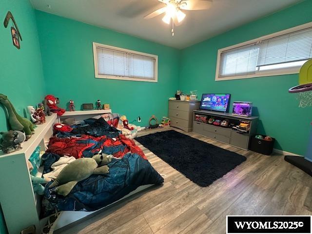 408 S 18th, Worland, WY 82401 - bedroom featuring wood finished floors, multiple windows, and ceiling fan