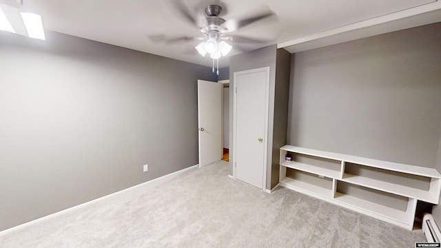 unfurnished bedroom with carpet flooring, ceiling fan, and a baseboard radiator