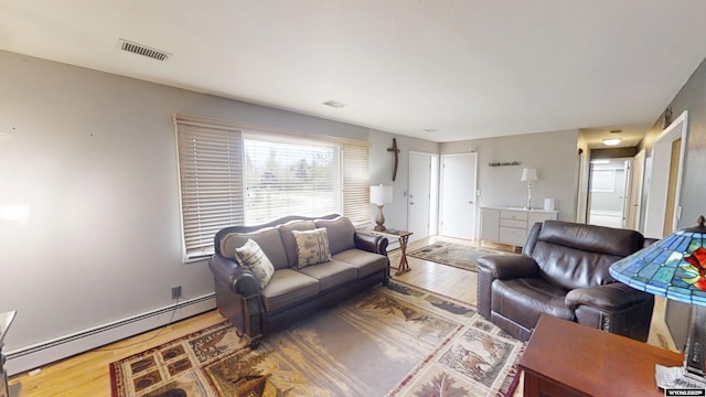 living area with wood finished floors and a baseboard radiator