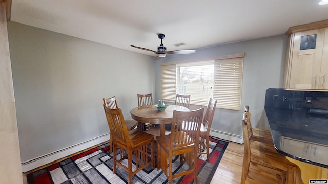 dining room with a baseboard radiator, light wood finished floors, and ceiling fan