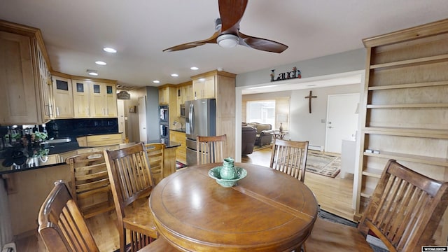 dining room featuring a ceiling fan, recessed lighting, wood finished floors, and baseboard heating
