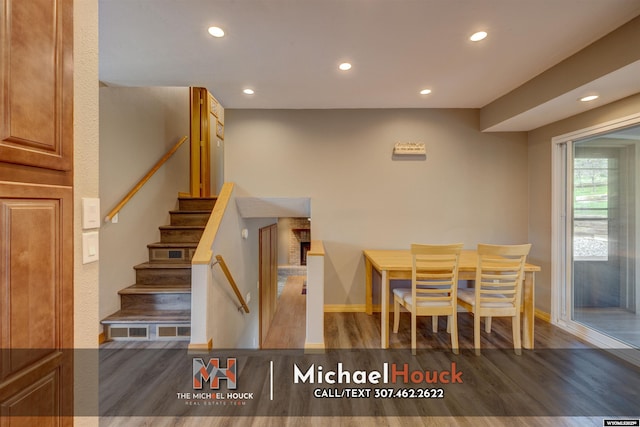 dining space featuring wood finished floors, recessed lighting, stairway, and baseboards