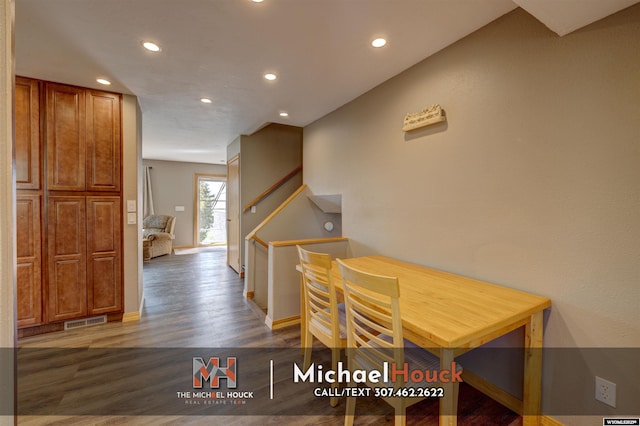 dining room with recessed lighting, wood finished floors, baseboards, and stairs