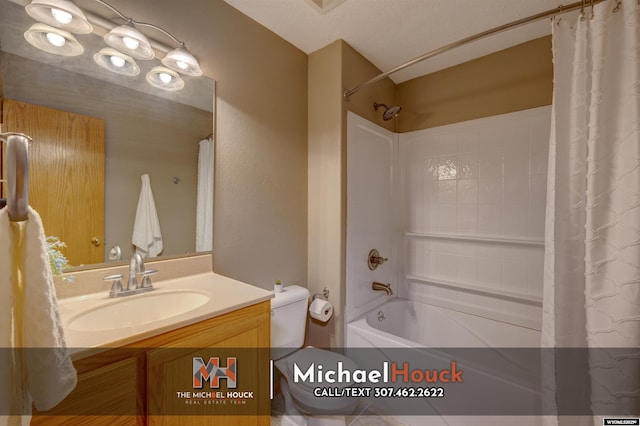 bathroom featuring shower / tub combo, vanity, and toilet