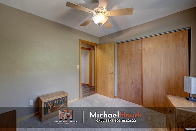 unfurnished bedroom featuring carpet floors, a ceiling fan, a closet, and baseboards