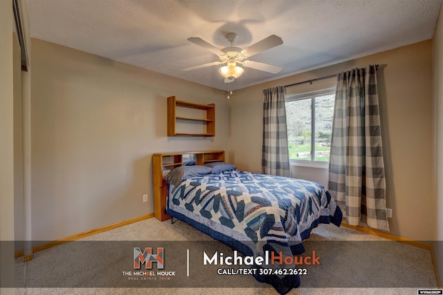carpeted bedroom featuring baseboards and a ceiling fan