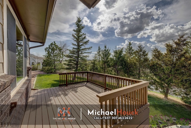 wooden deck with a lawn