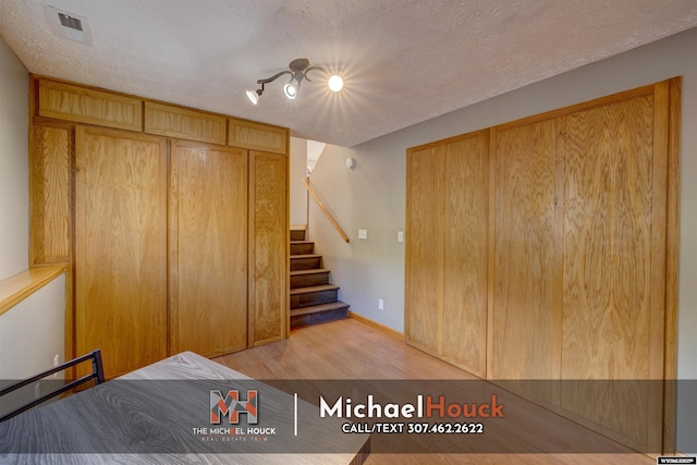 bedroom featuring light wood-style floors and a textured ceiling
