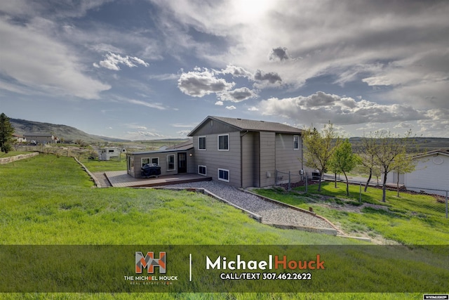 rear view of property with a deck with mountain view
