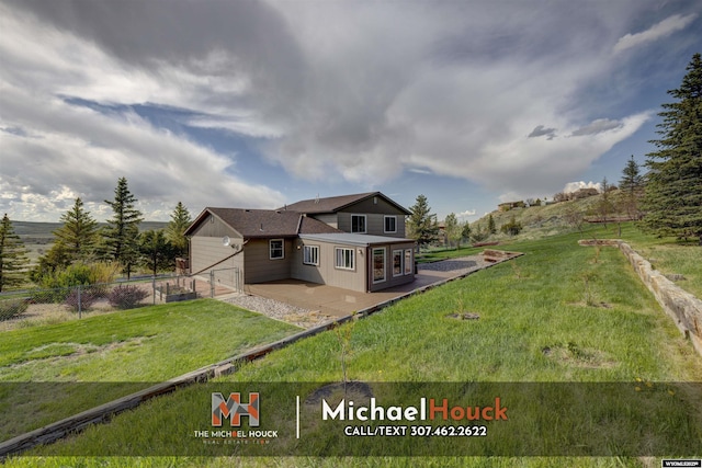 rear view of property featuring a patio area