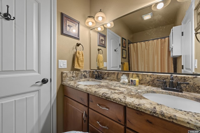 bathroom with double vanity and curtained shower