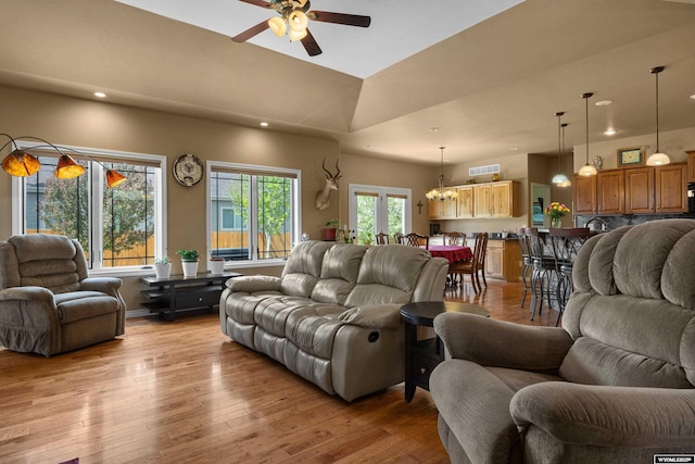 living area featuring recessed lighting, ceiling fan, light wood finished floors, a chandelier, and baseboards