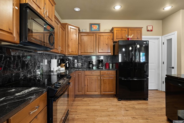 kitchen with black appliances, brown cabinets, tasteful backsplash, light wood-type flooring, and recessed lighting