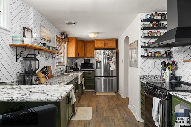 718 E 5th St, Casper, WY 82601 - kitchen with open shelves, appliances with stainless steel finishes, wall chimney exhaust hood, and brown cabinetry