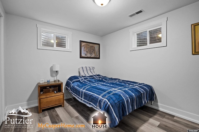bedroom featuring wood finished floors and baseboards