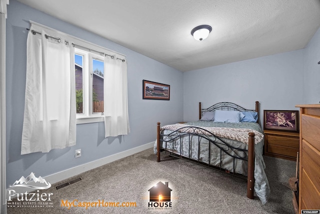 carpeted bedroom featuring baseboards
