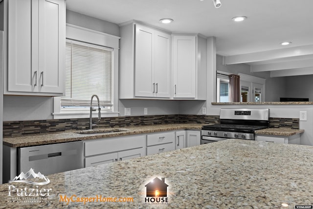 kitchen with stainless steel appliances, a sink, light stone countertops, beam ceiling, and recessed lighting
