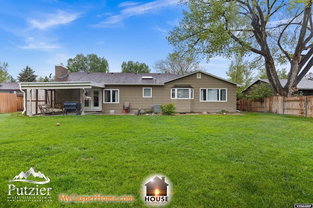 back of property with a sunroom and a chimney