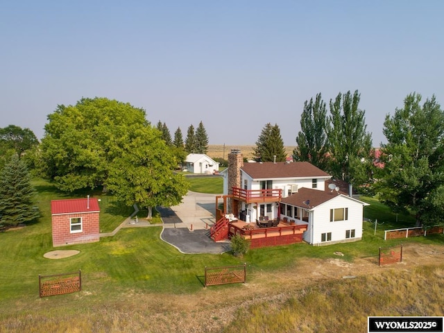 19A Kolman Ranch Rd, Rock Springs, WY 82901 - rear view of house featuring an outdoor structure, a patio, a deck, and a lawn