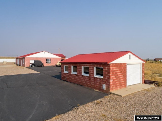 19A Kolman Ranch Rd, Rock Springs, WY 82901 - view of home's exterior featuring an outdoor structure, a garage, and metal roof