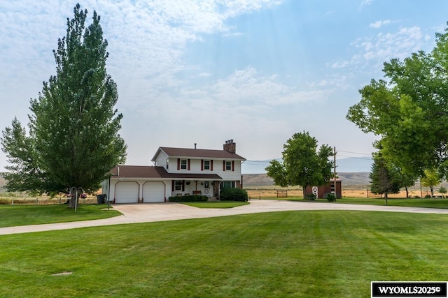 19A Kolman Ranch Rd, Rock Springs, WY 82901 - traditional-style home with concrete driveway, a garage, a front lawn, and a chimney