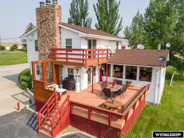 19A Kolman Ranch Rd, Rock Springs, WY 82901 - rear view of house featuring a wooden deck, a yard, a chimney, and outdoor dining area