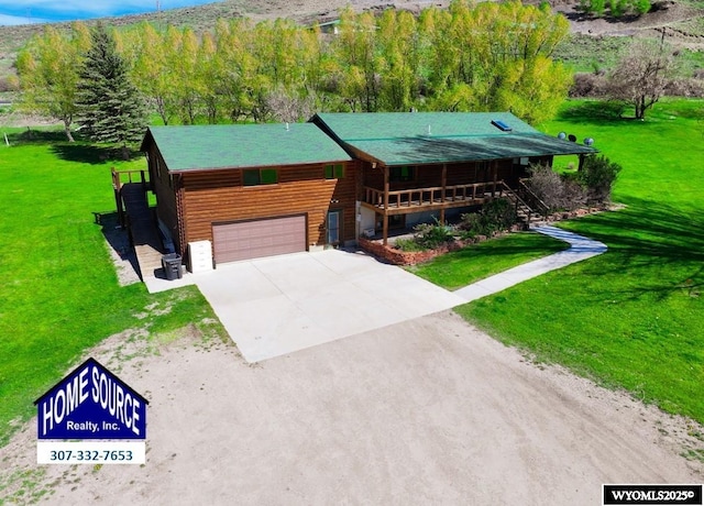 7 Raschell Ct, Lander, WY 82520 - log-style house with driveway, a garage, a front yard, and stairway