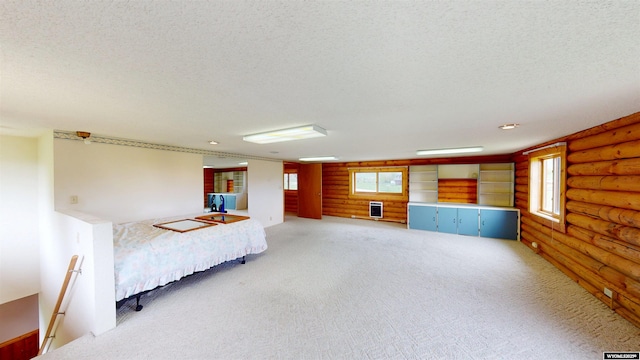 7 Raschell Ct, Lander, WY 82520 - unfurnished bedroom featuring log walls, light colored carpet, and a textured ceiling