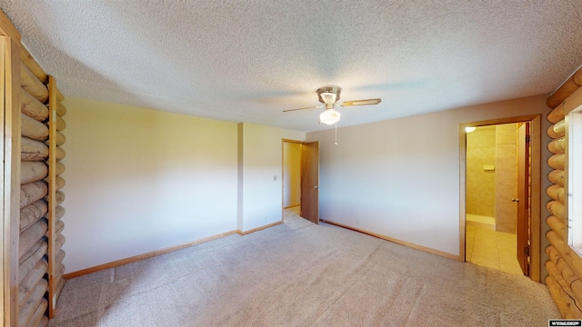 7 Raschell Ct, Lander, WY 82520 - unfurnished bedroom featuring light colored carpet, baseboards, a textured ceiling, connected bathroom, and a ceiling fan