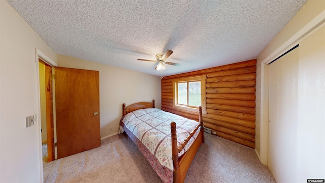 7 Raschell Ct, Lander, WY 82520 - bedroom featuring rustic walls, light carpet, a closet, a textured ceiling, and a ceiling fan