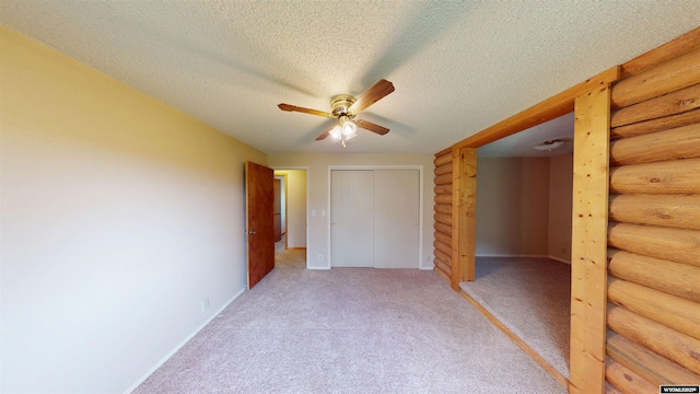 7 Raschell Ct, Lander, WY 82520 - unfurnished bedroom featuring light colored carpet, a closet, baseboards, and a textured ceiling