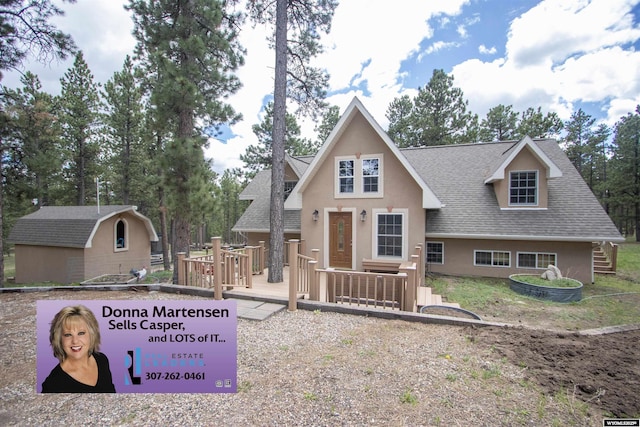 2908 Esterbrook Rd, Esterbrook, WY 82633 - view of front of home with a shingled roof, stucco siding, and a wooden deck