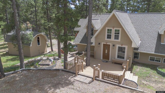 2908 Esterbrook Rd, Esterbrook, WY 82633 - view of front of home with stucco siding, roof with shingles, and a wooden deck