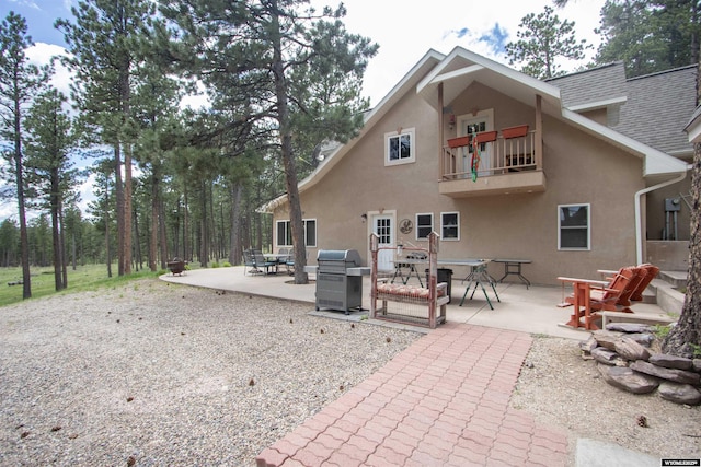 2908 Esterbrook Rd, Esterbrook, WY 82633 - rear view of property with a balcony, stucco siding, a patio, and outdoor dining area