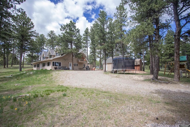 2908 Esterbrook Rd, Esterbrook, WY 82633 - back of property with a trampoline, driveway, and a playground