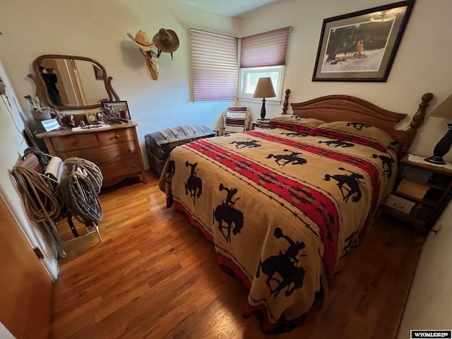 bedroom with wood finished floors