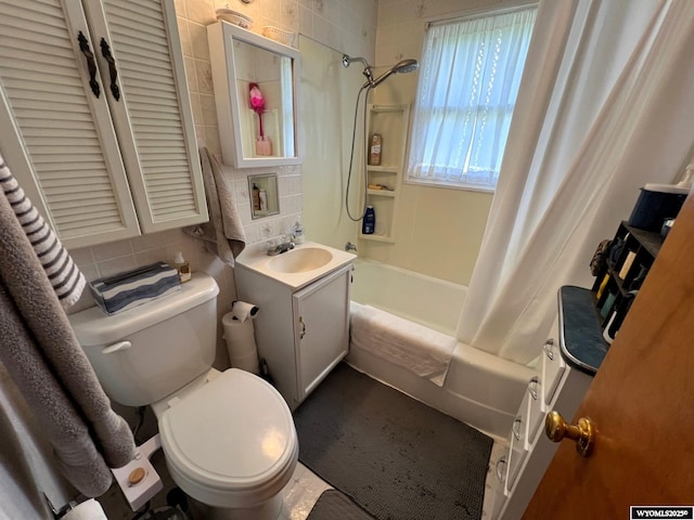 bathroom with shower / bath combo with shower curtain, vanity, toilet, tasteful backsplash, and tile walls