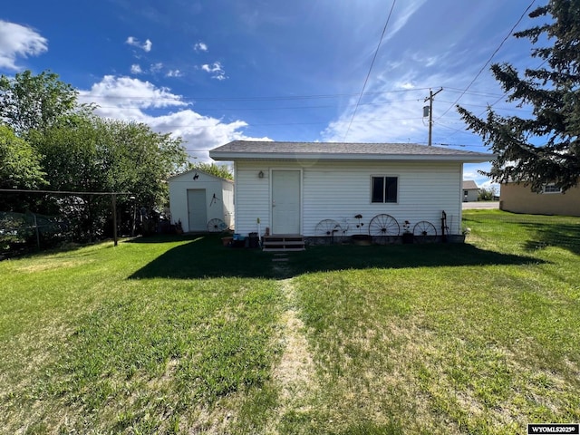 back of house featuring a yard and entry steps