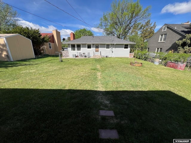 back of house featuring a yard, a chimney, and entry steps