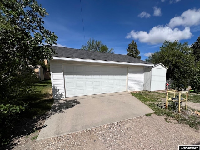 garage featuring a storage shed