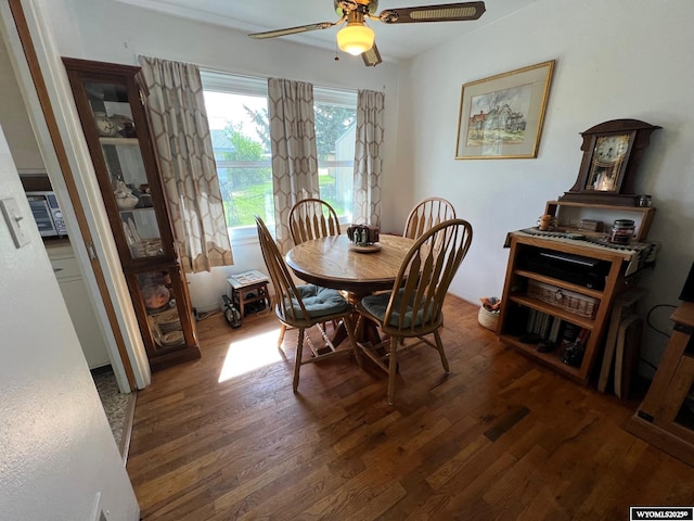 dining space with wood finished floors and ceiling fan