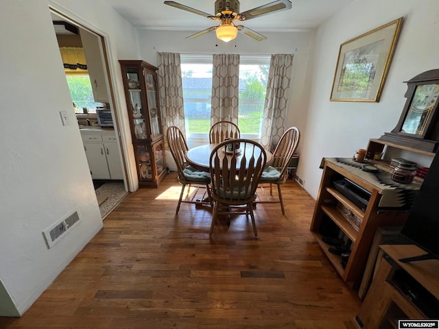 dining space with wood finished floors and ceiling fan