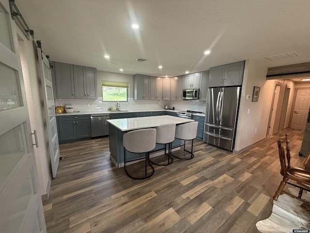 41 Ridgewater Ln, Douglas, WY 82633 - kitchen with stainless steel appliances, a sink, gray cabinets, dark wood-style floors, and recessed lighting
