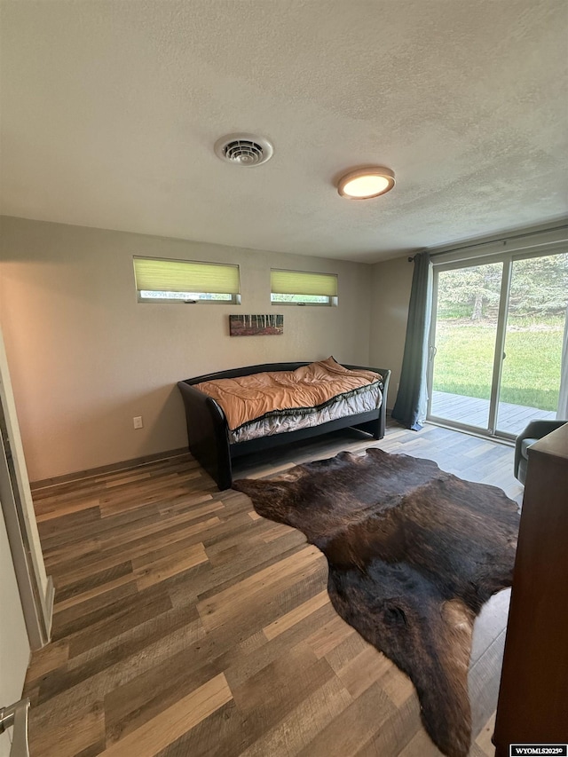 41 Ridgewater Ln, Douglas, WY 82633 - bedroom with access to exterior, wood finished floors, and a textured ceiling