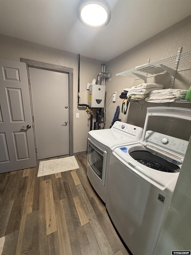 41 Ridgewater Ln, Douglas, WY 82633 - laundry room featuring washer and clothes dryer, dark wood-type flooring, and water heater