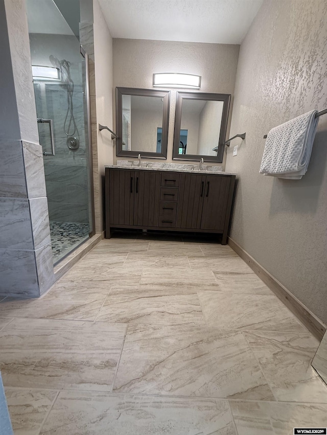 41 Ridgewater Ln, Douglas, WY 82633 - full bathroom with a textured wall, a shower stall, double vanity, and baseboards
