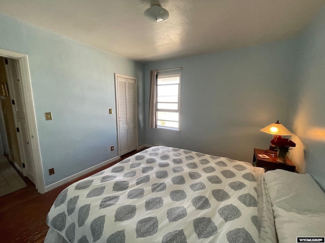 309 Cedar Ave, Kemmerer, WY 83101 - bedroom with a closet, baseboards, and wood finished floors