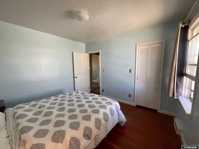 309 Cedar Ave, Kemmerer, WY 83101 - bedroom featuring dark wood-type flooring, baseboards, and a closet