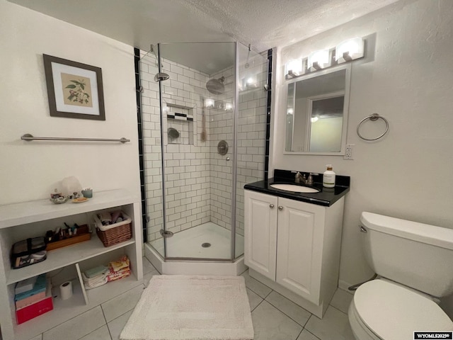 309 Cedar Ave, Kemmerer, WY 83101 - full bathroom featuring tile patterned flooring, a stall shower, toilet, a textured ceiling, and vanity