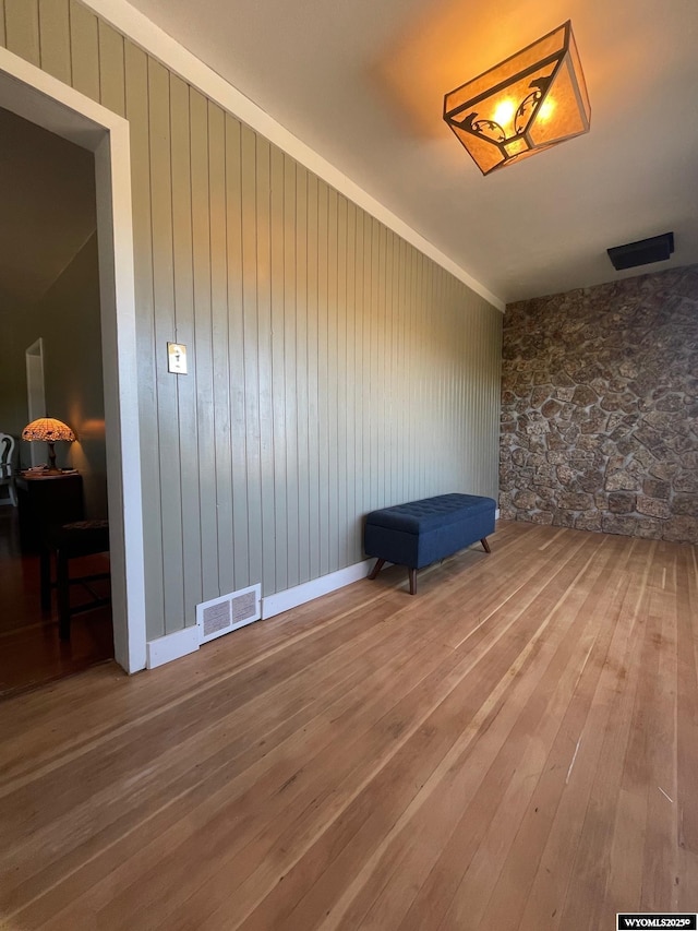 309 Cedar Ave, Kemmerer, WY 83101 - empty room featuring hardwood / wood-style floors and wood walls